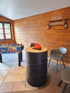 a room with a table and a hat on top at les quatres sources in Houffalize