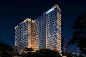 a large building with a sign on top of it at Keypai Hotel in Guangzhou