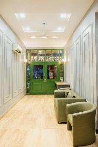 a room with two couches and a green door at Rupam Hotel - Air Purified comfort in New Delhi