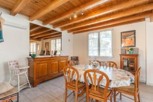 a kitchen and dining room with a table and chairs at Lumineux appart à 300m de la plage in La Tremblade +14 photos