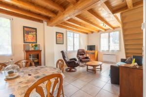 a living room with a table and chairs at Lumineux appart à 300m de la plage in La Tremblade
