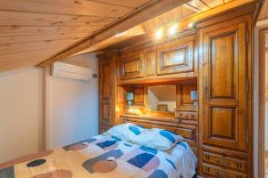 a bedroom with a bed and a wooden wall at Lumineux appart à 300m de la plage in La Tremblade