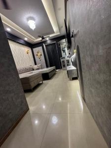 a hallway with a bed and a couch in a room at A5 tower flat number 708 in Karnal +3 photos