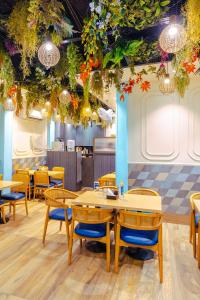 a restaurant with tables and chairs and plants on the ceilings at Rupam Hotel - Air Purified comfort in New Delhi