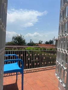 a blue bench sitting in front of a fence at 3Bedroom Hilltop Home In Muyenga in Kampala
