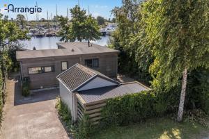 an aerial view of a house next to a marina at Havenrust 4-persoons aan het water Lauwersmeer, Friesland in Anjum