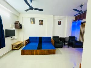 a living room with a bed and a tv at 1 BHK flat in Guruvayur - Sooryamadhavam Apartments-only for pilgrims in Guruvāyūr