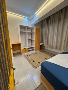 a bedroom with a bed and a desk and cabinets at Omars shalet in Dahab