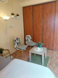 a room with two chairs and a table and a bed at Romantik Apartment with Self-Check-in in Staré Mesto