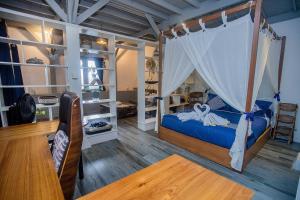 a bedroom with a bed with a canopy at Moonlight Villa Close By Blue Lagoon in Nusa Ceningan +55 photos