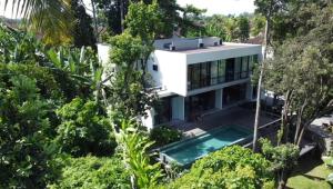 an aerial view of a white house with a swimming pool at Maxwell Villa Bali in Tabanan