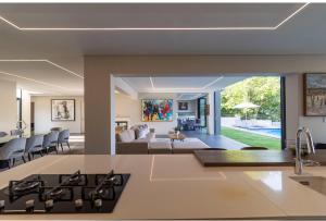 an open kitchen and living room with a couch at Thalia House in Johannesburg
