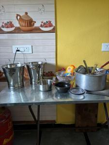 a table with many pots and pans on it at Pooja Farmhouse in Hyderabad