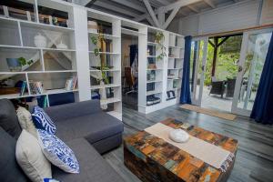 a living room with a couch and a table at Moonlight Villa Close By Blue Lagoon in Nusa Ceningan