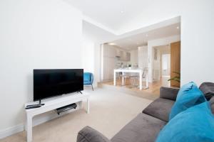 a living room with a couch and a flat screen tv at Romford - Balcony - Outdoor Space - Parking Space in Romford