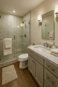a bathroom with a toilet and a sink and a shower at Venice Boardwalk Breeze 2BR - 7-min to Venice Beach in Los Angeles