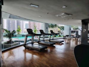 a gym with a row of treadmills in a building at Swiss garden residence in Kuala Lumpur