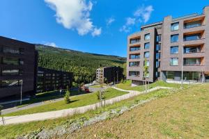 a building on a hill next to a building at Apartment SKY in Dolní Morava