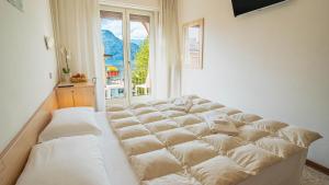 Postel nebo postele na pokoji v ubytování Hotel Sorriso