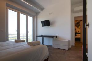 a bedroom with a bed and a desk with a television at Casa Le Vaglie in Barbara