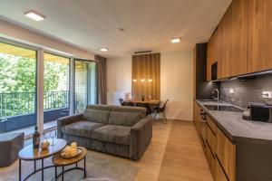 a kitchen and living room with a couch and a table at Apartment SKY in Dolní Morava