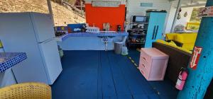 a kitchen with a blue floor and a sink in a room at My Little Shack by the Sea in Lajas +24 photos