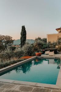 a swimming pool in the backyard of a house at The Olive Grove in Tuscany in Toiano