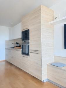 a kitchen with wooden cabinets and a stove and microwave at Kerzen Boutique in Bad Salzuflen