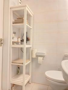 a white bathroom with a toilet and a sink at Kerzen Boutique in Bad Salzuflen +12 photos