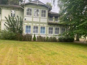 a large house with a yard in front of it at Baltic beach villa 2 in Jūrmala