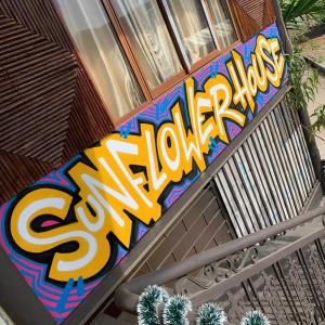 a sign on the side of a building at Sunflower House - Ha Giang Loop Tour in Bản Kin +1 photo