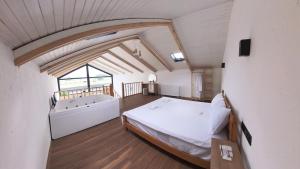 a bedroom with a large bed and a bath tub at Terra Viva Villa's in Erenköy +43 photos
