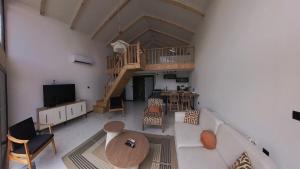 an overhead view of a living room with a staircase at Terra Viva Villa's in Erenköy