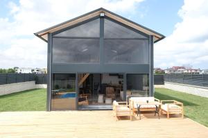 a glass house with a table and chairs on a deck at Terra Viva Villa's in Erenköy