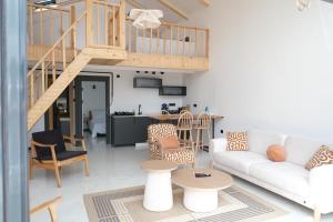 a living room with a white couch and a staircase at Terra Viva Villa's in Erenköy