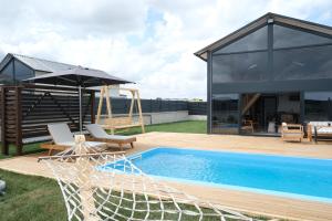 a house with a swimming pool and a patio at Terra Viva Villa's in Erenköy