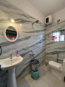 a bathroom with a sink and a toilet at Coorgsierra in Madikeri