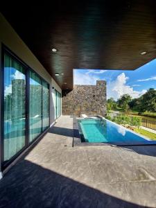 a house with a swimming pool on a balcony at Song View Pool Villa in Vang Vieng