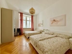 a bedroom with two beds and a window at Renovated Spacious Apartment with Free Parking in Vienna