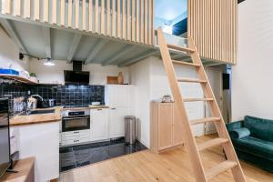 a kitchen with a loft bed in a room at Magnifique appartement en centre ville in Montpellier +15 photos