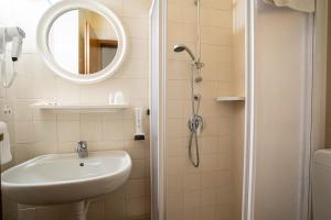 a bathroom with a sink and a mirror at Hotel Sorriso in Brenzone sul Garda +42 photos