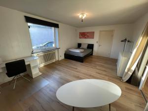 a small room with a white table and a bed at Modern 7-Bedroom Villa for Large Families & Groups in Rødby +30 photos