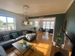 a living room with a couch and a table at Exclusive villa by the sea, close to Saltstraumen in Bodø