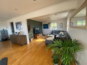 a living room with a couch and a table at Exclusive villa by the sea, close to Saltstraumen in Bodø