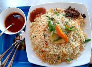 a plate of rice with vegetables and a bowl of sauce at Grandmila Resort in Anuradhapura