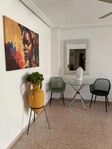a room with a table and two chairs and a painting at Casa Marquesa in Rojales