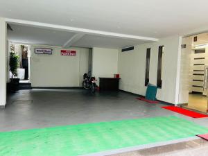 a room with a mat in the middle of a building at Hotel Mauli Lodging in Ahmadnagar