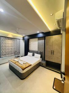 a bedroom with a large bed in a room at Hotel Mauli Lodging in Ahmadnagar +21 photos