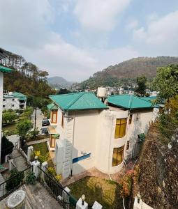 an aerial view of a house with a green roof at Kamlam Homes- Bhowali Villa in Bhowāli