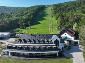 an aerial view of a large building with a green field at Hotel Arena Maribor in Maribor